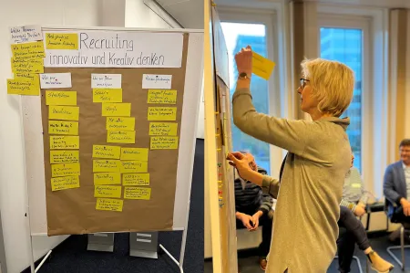 Ute Flügge heftet Karten an eine Metaplanwand.